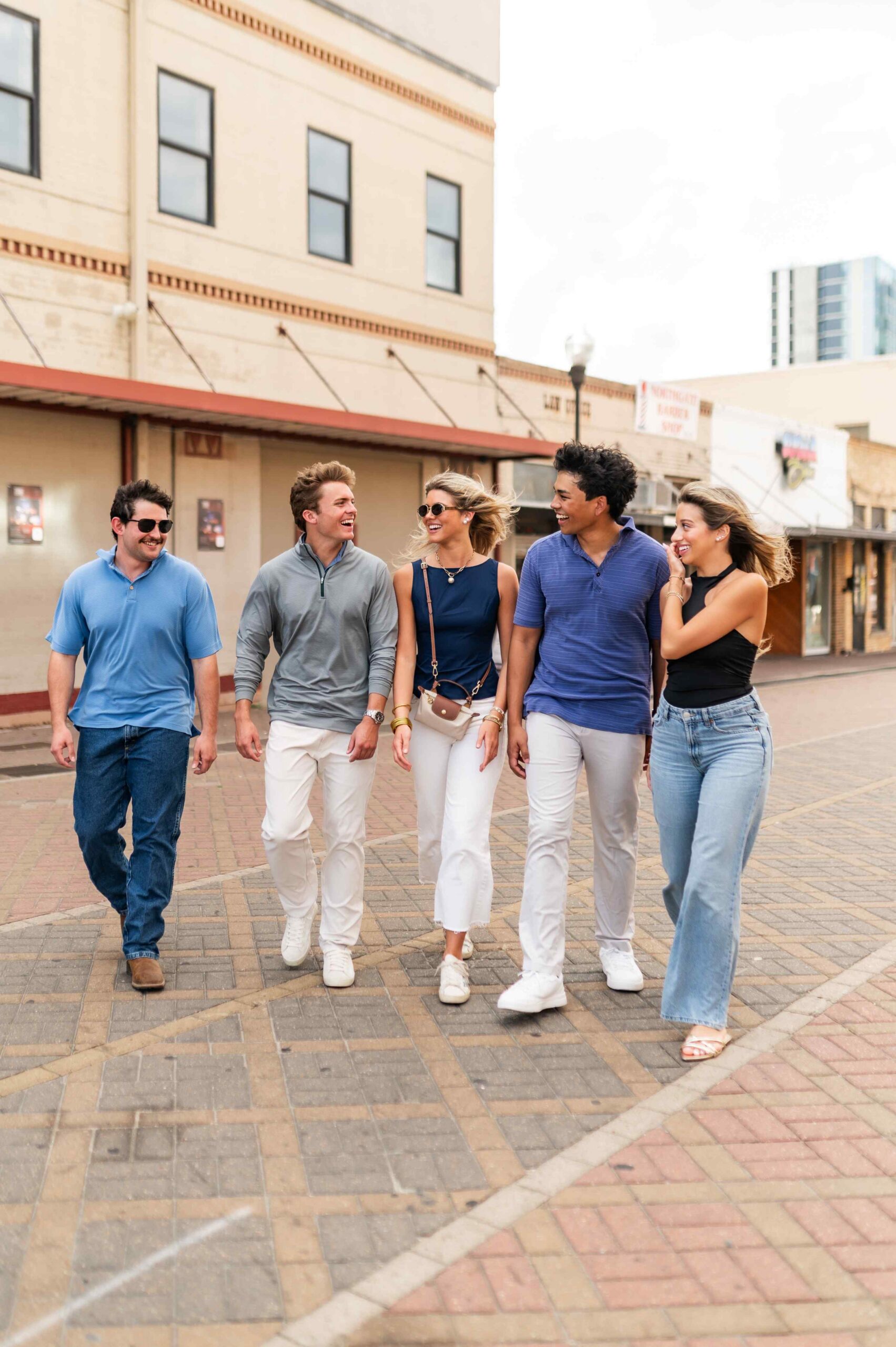 five young adults walking and laughing near honcho in college station tx scaled
